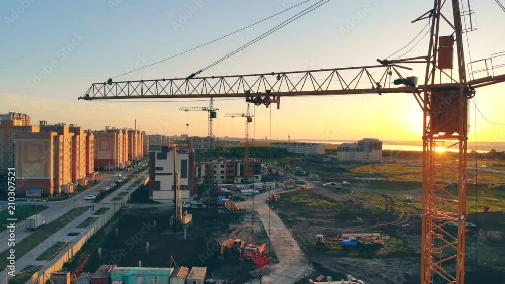 Construction crane on a site. Construction Site At Sunset.