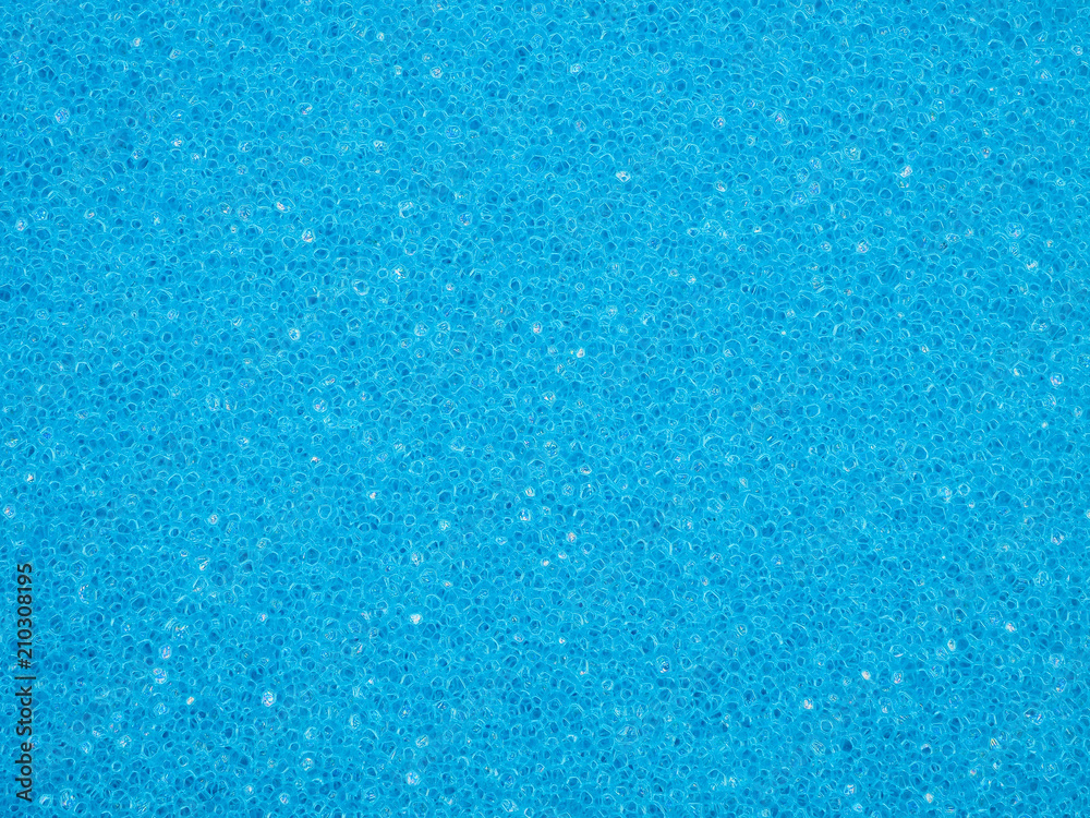 Close-up of porous texture of blue sponge. Crystalline granular design for background or wallpaper. High-quality macro photography.