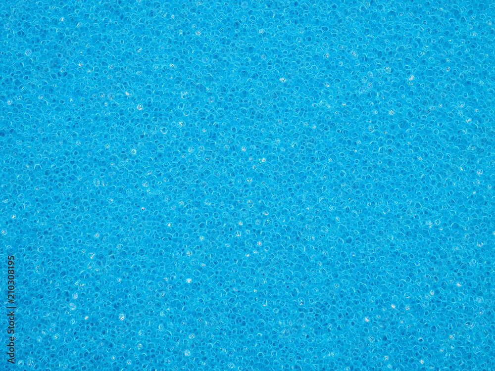 Close-up of porous texture of blue sponge. Crystalline granular design for background or wallpaper. High-quality macro photography. Close-up of porous texture of blue sponge. Crystalline granular design for background or wallpaper. High-quality macro photography.