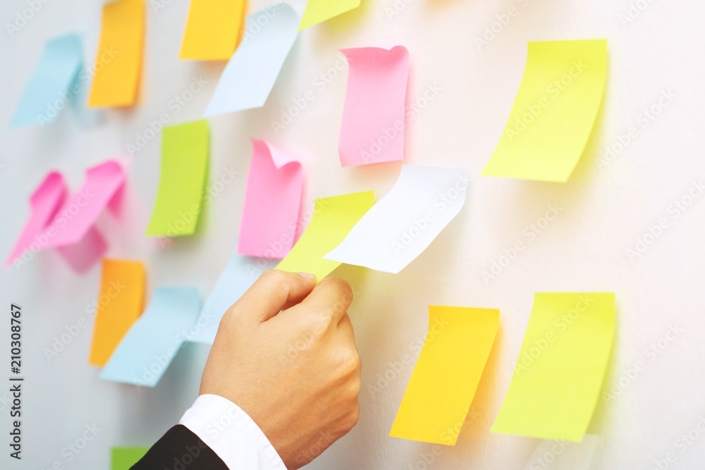 close up hand people business man post it notes in the wall at meeting  room. Sticky note paper reminder schedule board. Colorful variety copy  empty space. soft focus. Photos | Adobe Stock