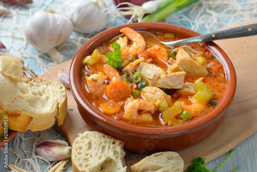 Mediterrane Fischsuppe mit frischem Weißbrot serviert – Mediterranean bouillabaisse ( French fish soup ) served with fresh white bread photo