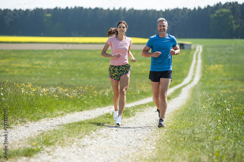 Couple running on field path