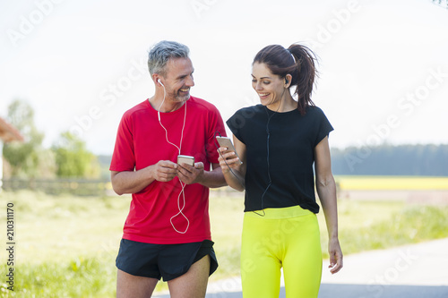 Couple using smartphones during workout