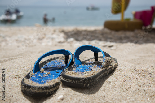 Blue flip-flops on the beach