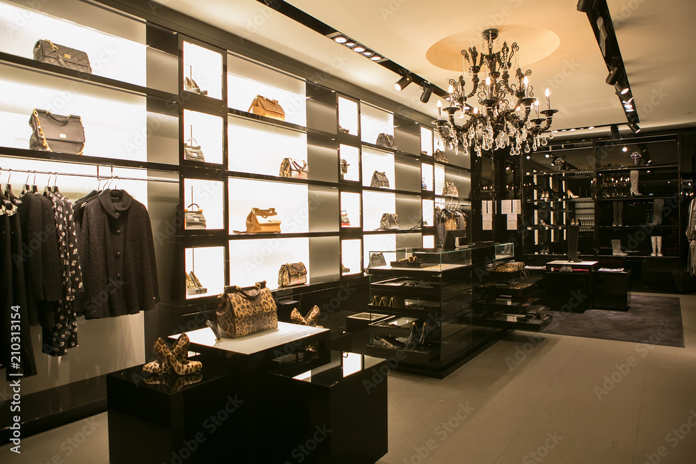 Behang bright and fashionable interior of shoe store in modern mall