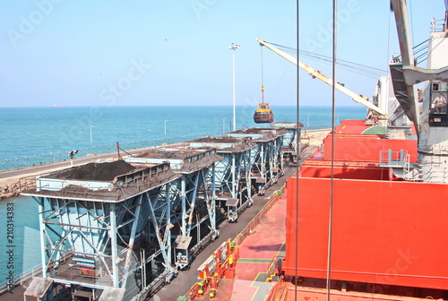 Выгрузка балкера судовыми кранами в порту Тутикорин, Индия. 
