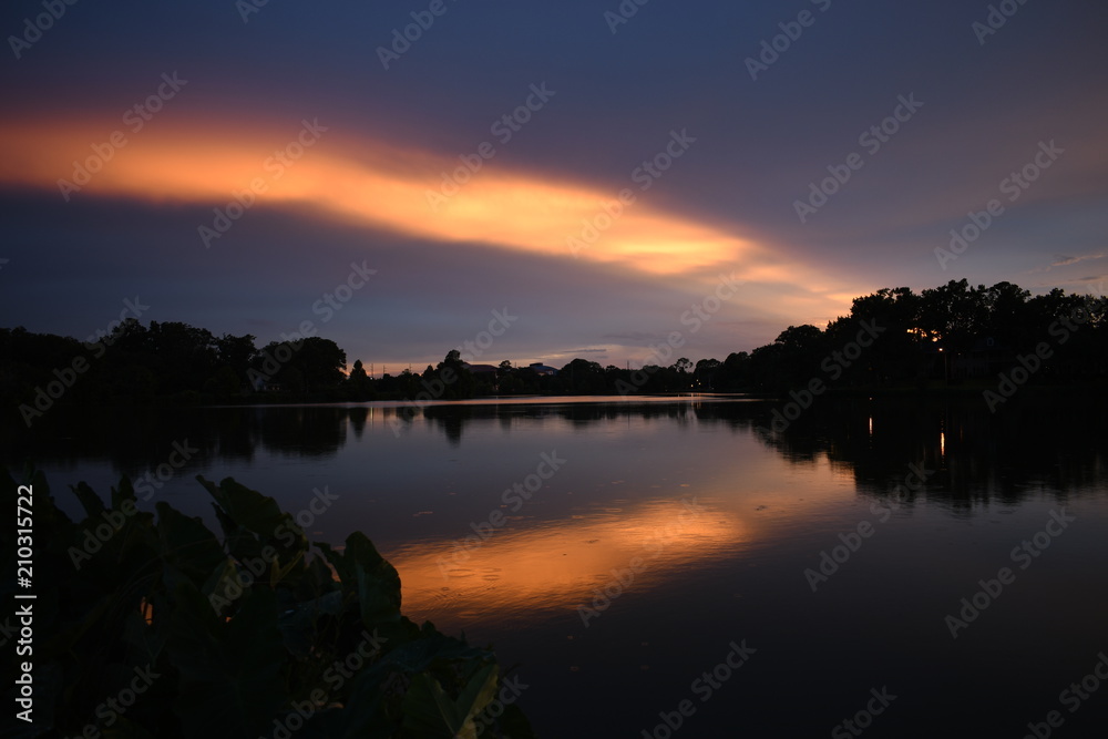 A radiant sunset is cast over a beautiful lake revealing the most beautiful colors of the day time right before night. A radiant sunset is cast over a beautiful lake revealing the most beautiful colors of the day time right before night.