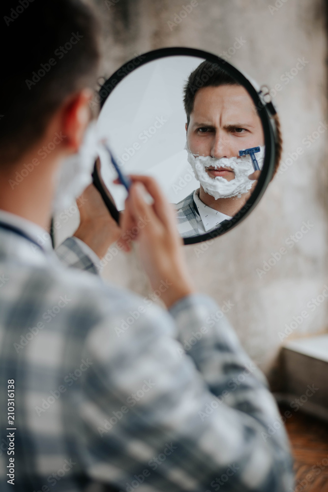 morning routine: a man shaving before going to work. morning routine: a man shaving before going to work.