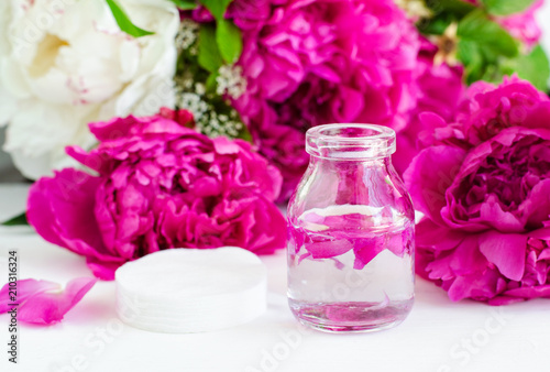 Small glass bottle of peony tincture (water infusion, extract, perfume). Copy space. 