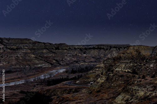 A hiking path way leading across the grassland canyons showing nothing but the most scenic views known to man under the radiant stars.