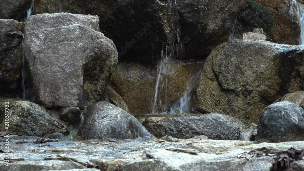 small waterfall between the rocks in the woods small waterfall between the rocks in the woods