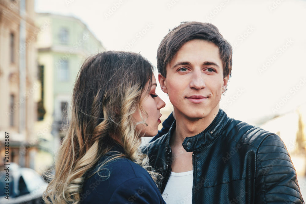 Happy couple is spending vacation holidays in St. Petersburg. Both look really happy. They are strolling along the streets of the old town Happy couple is spending vacation holidays in St. Petersburg. Both look really happy. They are strolling along the streets of the old town
