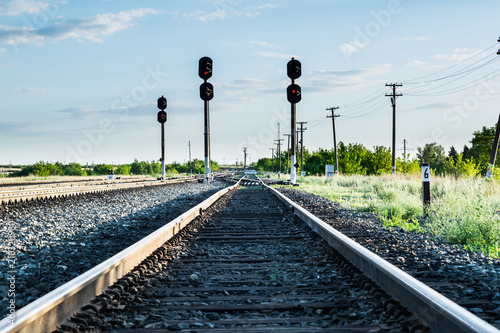 Railway tracks with semaphores and a pole with the number six photo