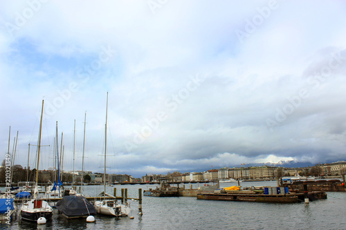 Geneva, Switzerland - March 30,2018: Street view on famous lake and yachts on rainy day
