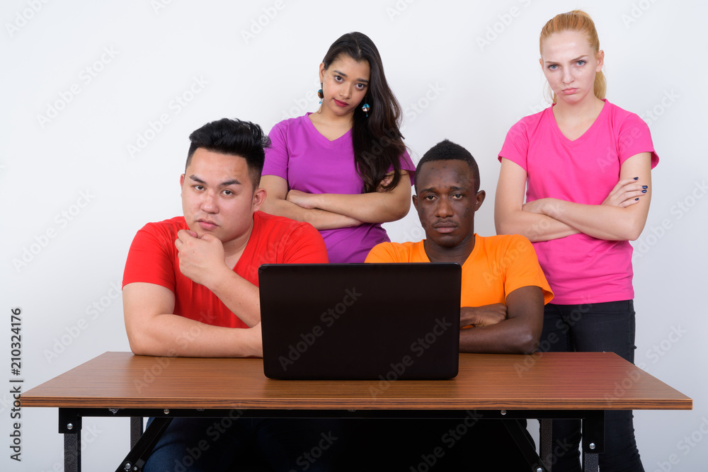 Studio shot of diverse group of multi ethnic friends with arms c Studio shot of diverse group of multi ethnic friends with arms c