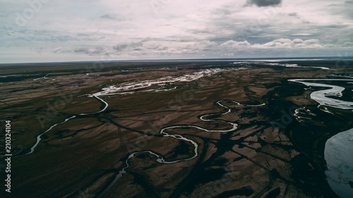 aerial view of river in black sand with many junctions photo