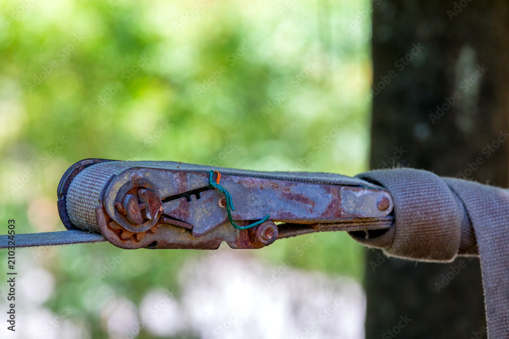 Old ratchet straps for cargo control.Mechanism of tension of awning