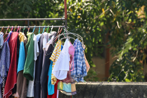 Clothes line, outdoor sunlight outdoors, hang clothes launch day in the countryside. Clothing colors in clothes © cgdeaw