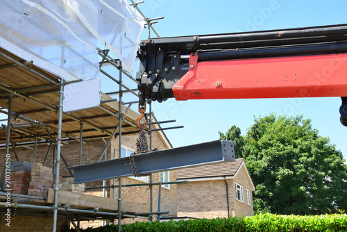 A crane lifting a girder into position.
 photo