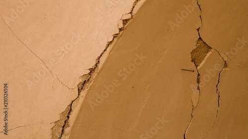A medium shot of cracks of walls. The cracks are found on the old town in Ferdows. photo
