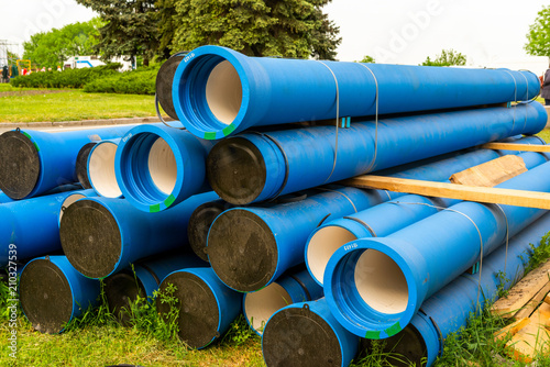 Large blue water pipes on the street before laying