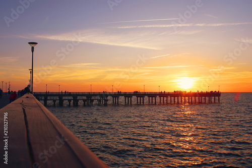 View of sea sunset with bridge. Baltic sea beach bridge in Palanga.