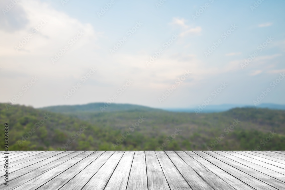 Old dark wood table or floor on landscape view with green plant and mountain, can be used to present product Old dark wood table or floor on landscape view with green plant and mountain, can be used to present product