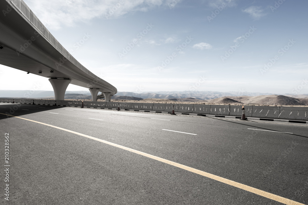 Naklejka premium asphalt road with city skyline