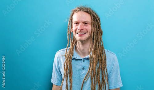 Valokuva Happy young man with dreadlocks on a solid background