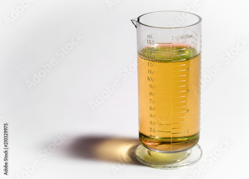 Beaker or flask with yellow liquid isolated on white background