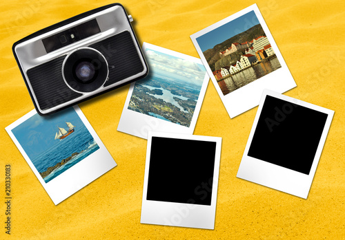 Oldfasioned camera and photo frames cards on yellow sandy background photo