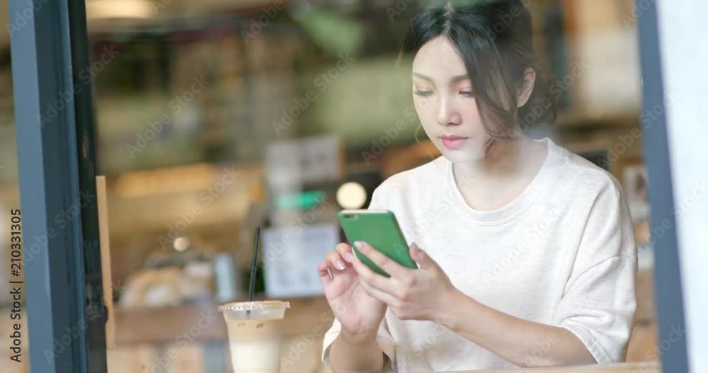Woman use of mobile phone in cafe Woman use of mobile phone in cafe