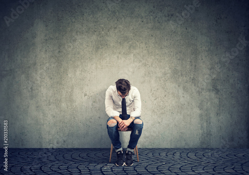 Sorrowful lonely man on chair photo