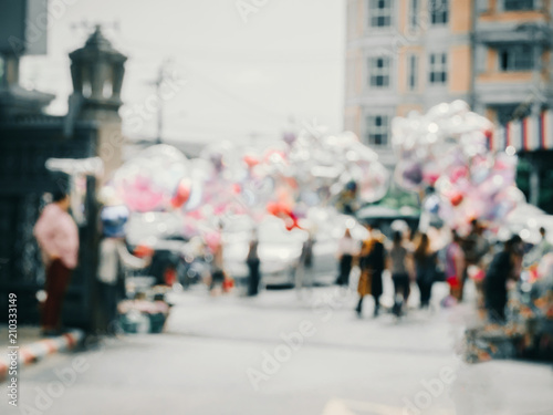 abstract blur: festival , party , event , university graduation ceremony with balloon seller and shop background