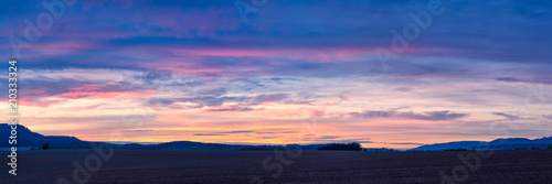Colorful sunset over plowed fields in Northern Bohemia in the Czech Republic, Europe