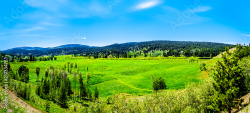 Farm fields surrounded by the Coastal Mountains along Highway 5A, the Kamloops-Princeton Highway, between the towns of Merritt and Princeton in British Columbia, Canada 