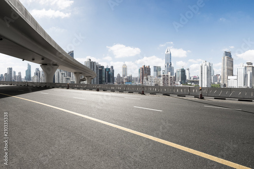 asphalt road with city skyline