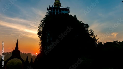 Time lapse Beautiful sunrise with pagoda on the top of mountain at Khao Na Nai Luang Dharma Park,Surat thani province,Thailand. Camera Tilt up