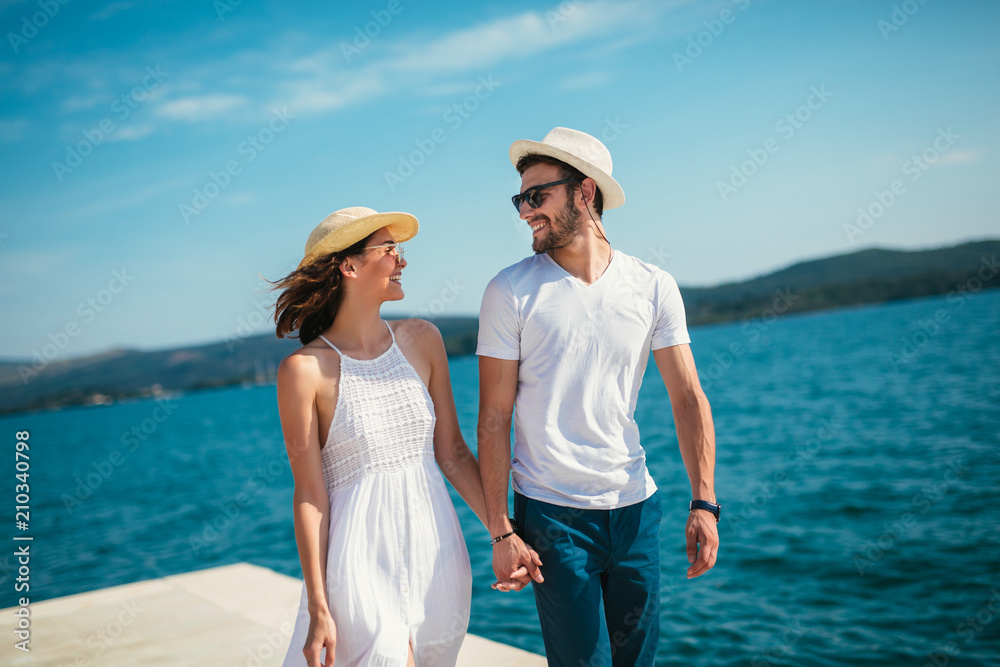 Couple in love, enjoying the summer time by the sea. Couple in love, enjoying the summer time by the sea.