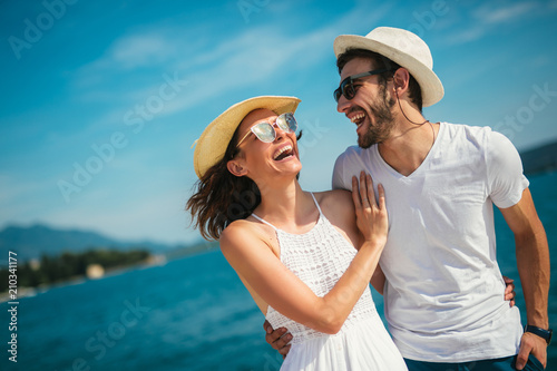 Couple in love, enjoying the summer time by the sea.