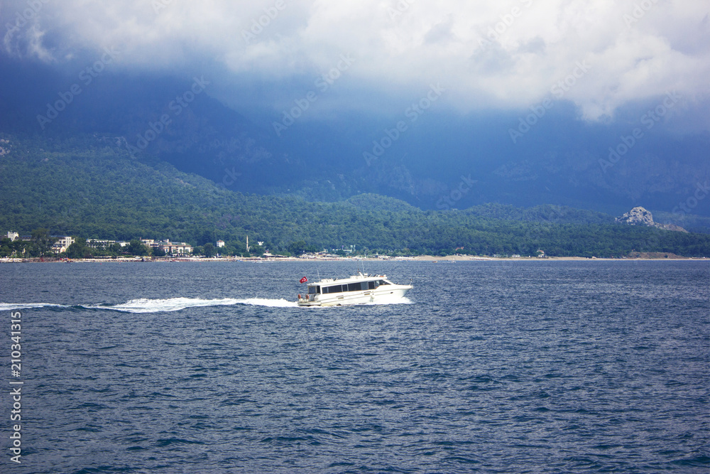 Blue calm Mediterranean Sea, mountains and white yacht Blue calm Mediterranean Sea, mountains and white yacht