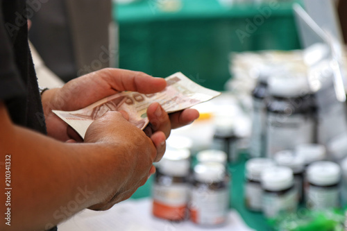 old man paying money for drugs (Selective focus)