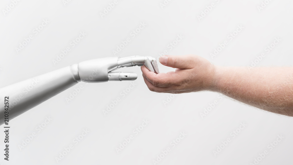 Roboter Hand greift menschliche Hand - obrazy, fototapety, plakaty 