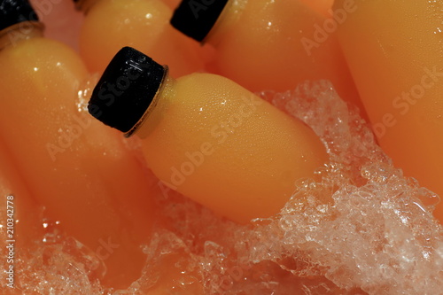 Orange Juice fresh in bottle ice cooler at market street food (Selective Focus)