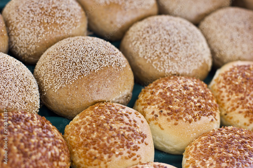 Fresh buns from yeast dough with sesame and poppy seeds