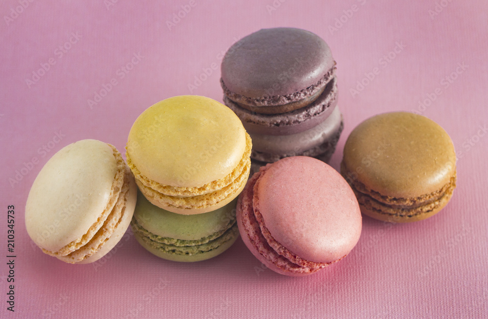 A Variety of French Macarons Flavors on a Pink Background A Variety of French Macarons Flavors on a Pink Background