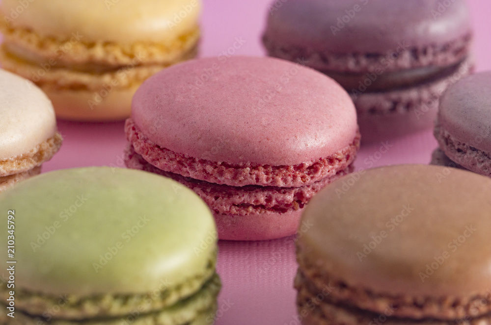 Fototapeta premium A Variety of French Macarons Flavors on a Pink Background
