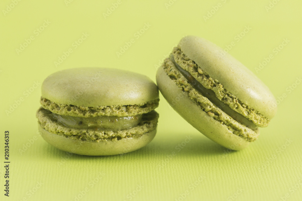 Green French Macarons on a Green Background