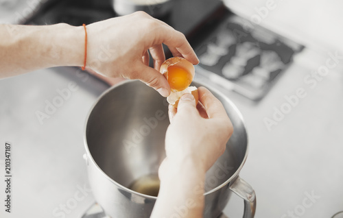 Cook pours egg in metal plate photo