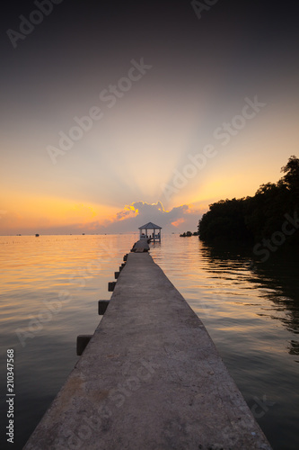 silhouette long cement walkway to pavilion at sunrise morning